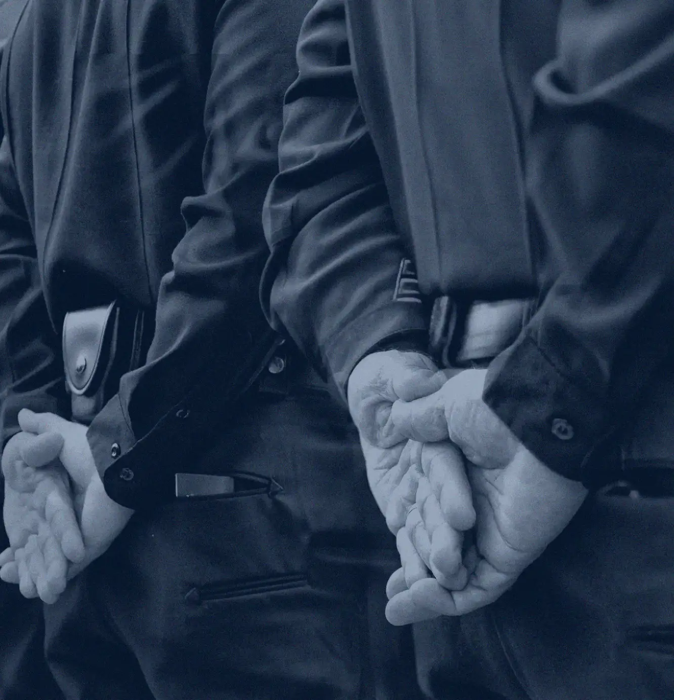 Officers holding their hands behind ther backs